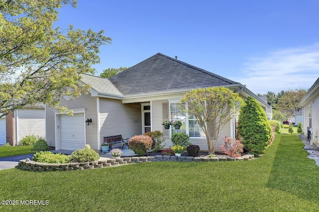 view of front of property with an attached garage and a front yard