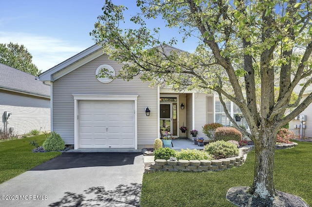 view of front of property with an attached garage, aphalt driveway, and a front lawn