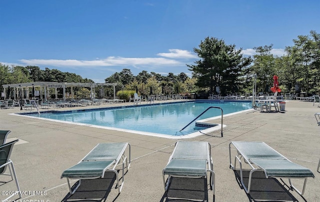 community pool featuring a pergola and a patio area