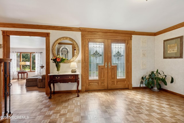 foyer entrance featuring baseboards, ornamental molding, and french doors