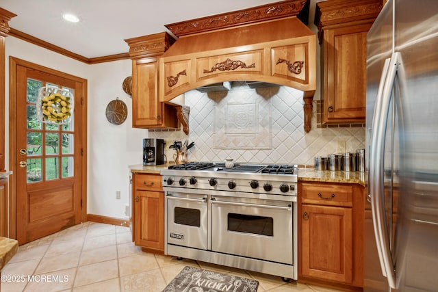 kitchen with light tile patterned floors, appliances with stainless steel finishes, tasteful backsplash, and light stone countertops