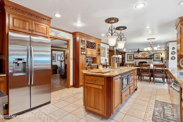 kitchen featuring recessed lighting, light stone countertops, appliances with stainless steel finishes, and light tile patterned floors