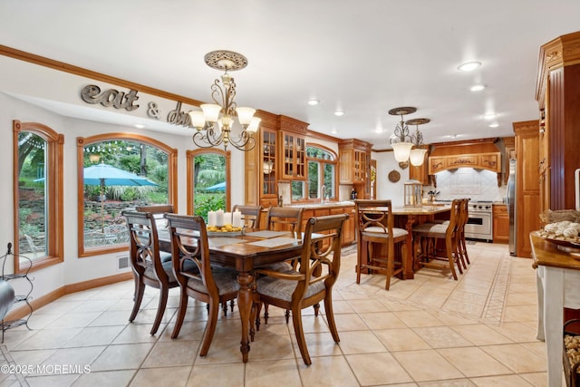 dining room with a notable chandelier, recessed lighting, baseboards, light tile patterned floors, and ornamental molding