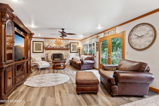 living room with a fireplace, a ceiling fan, recessed lighting, wood finished floors, and ornamental molding