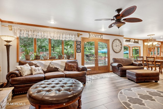 living area with recessed lighting, ornamental molding, and ceiling fan with notable chandelier
