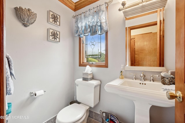 half bath featuring a sink and toilet