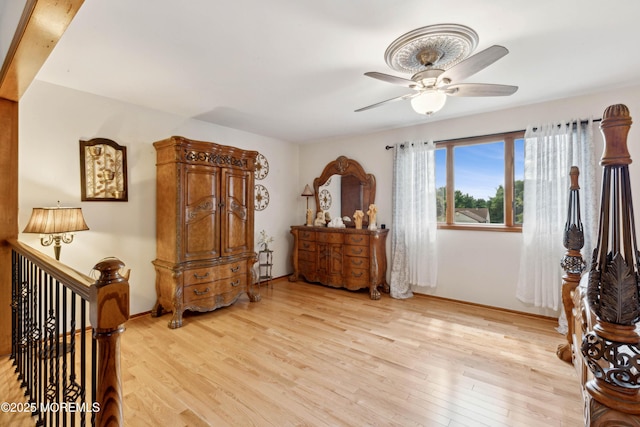 bedroom with light wood-type flooring, baseboards, and ceiling fan