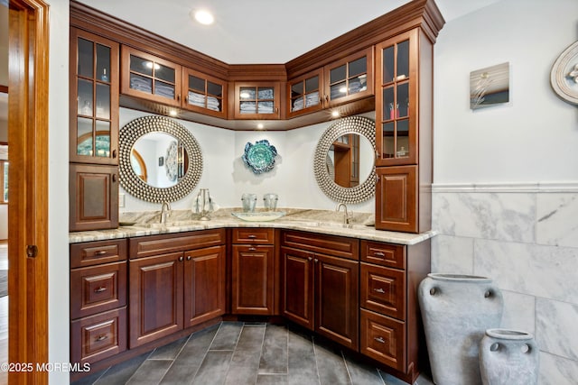 full bath featuring a sink, tile walls, tile patterned flooring, and double vanity