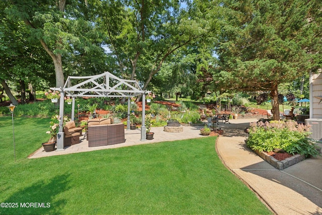 view of yard featuring an outdoor living space with a fire pit, a patio, and cooling unit