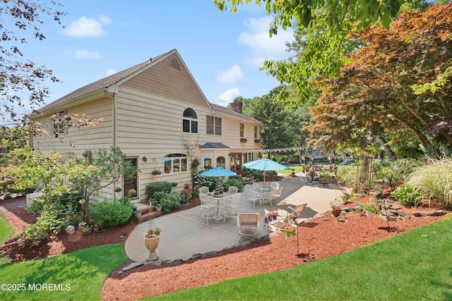back of house featuring a patio and a chimney