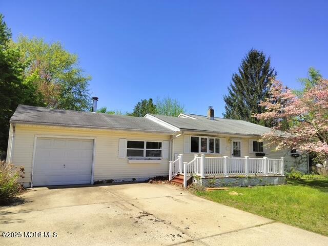 ranch-style house with a garage, a wooden deck, and driveway