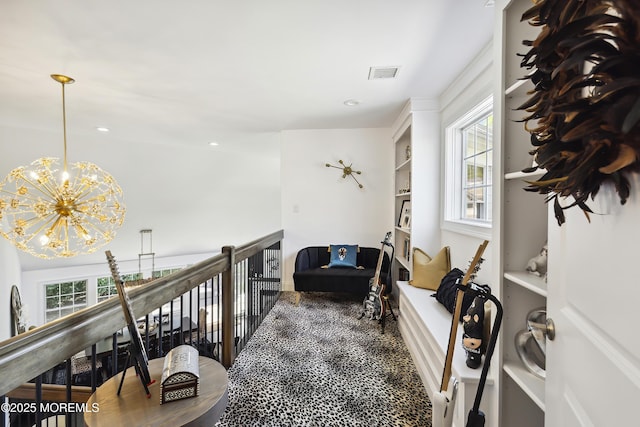 hall featuring visible vents, an upstairs landing, an inviting chandelier, recessed lighting, and dark carpet