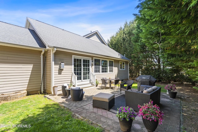 rear view of property with a patio area, a yard, outdoor lounge area, a shingled roof, and entry steps