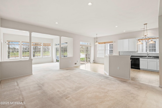 kitchen featuring light carpet, a sink, black dishwasher, recessed lighting, and open floor plan