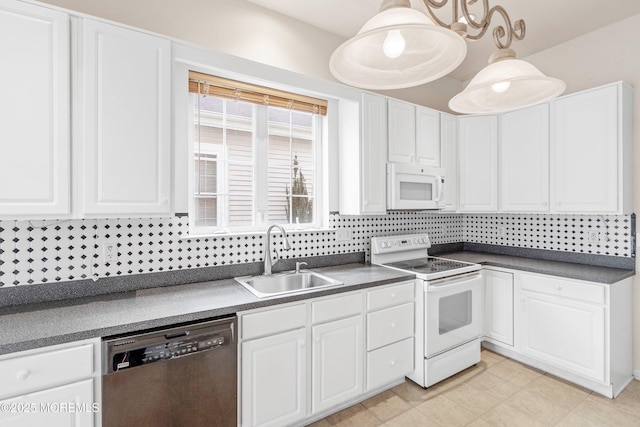 kitchen featuring decorative backsplash, dark countertops, a sink, white cabinets, and white appliances
