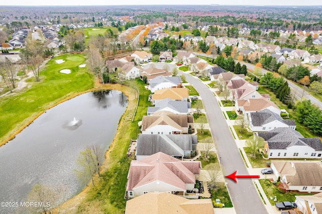 bird's eye view with a residential view, view of golf course, and a water view