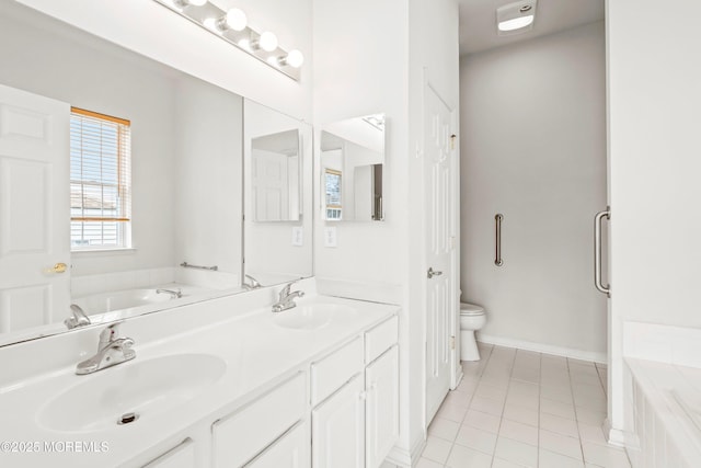 full bathroom with toilet, tile patterned floors, a sink, and a garden tub