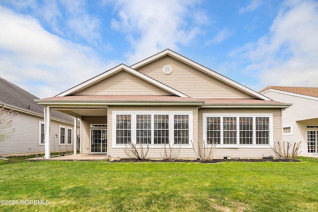 back of house with a patio and a yard