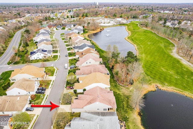 aerial view featuring a water view, view of golf course, and a residential view