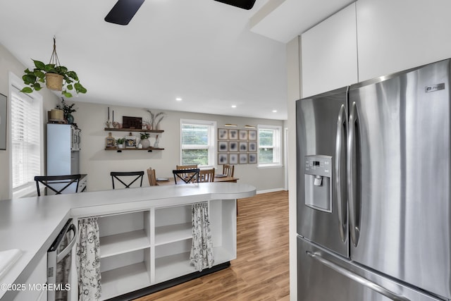 kitchen with recessed lighting, stainless steel appliances, a ceiling fan, light wood-style flooring, and white cabinets