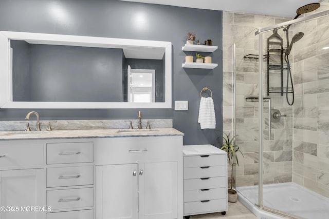 full bath featuring double vanity, a shower stall, and a sink