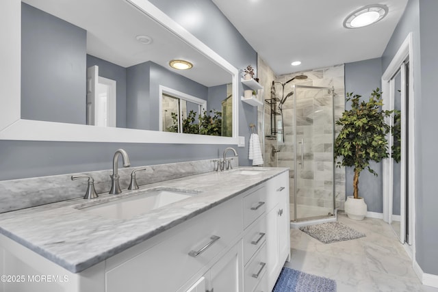 bathroom featuring marble finish floor, a sink, and a shower stall