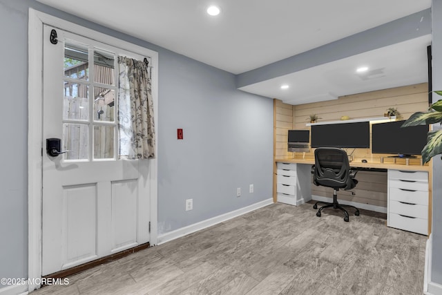 office space with built in desk, recessed lighting, wood finished floors, and baseboards