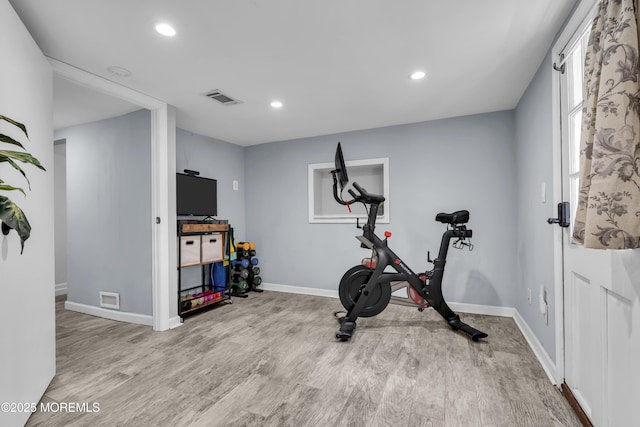 exercise room with recessed lighting, visible vents, and wood finished floors