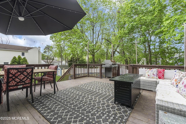 wooden deck featuring grilling area and an outdoor living space