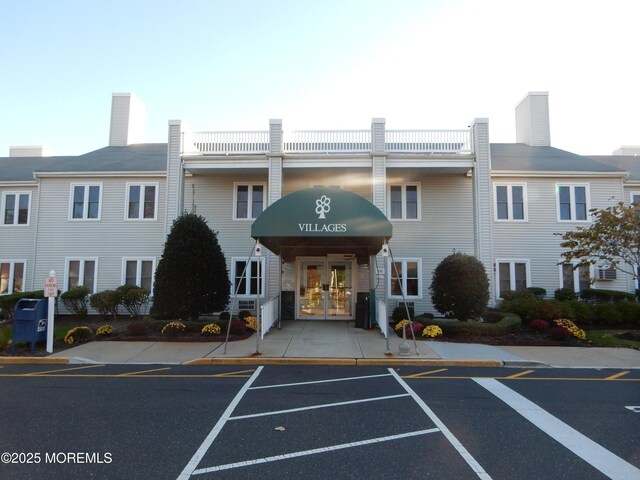 view of property featuring uncovered parking