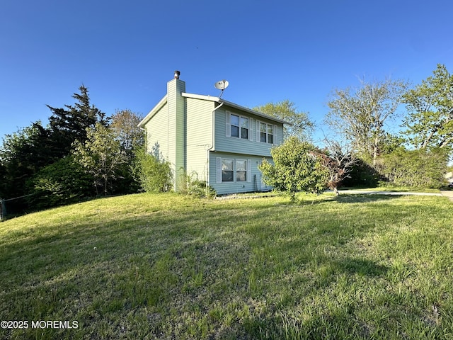 136 Windward Dr, Barnegat, NJ 08005 - view of home's exterior with a yard and a chimney
