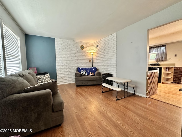 136 Windward Dr, Barnegat, NJ 08005 - living area with brick wall and wood finished floors