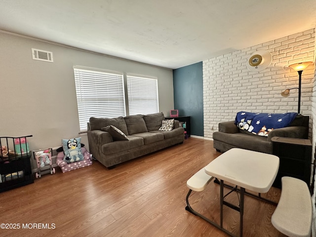 136 Windward Dr, Barnegat, NJ 08005 - living room featuring visible vents, wood finished floors, and brick wall