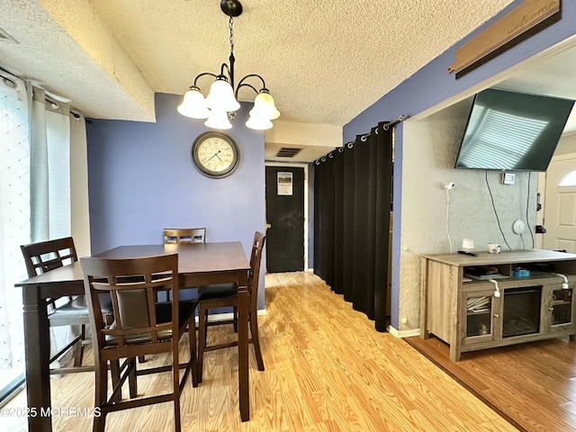 136 Windward Dr, Barnegat, NJ 08005 - dining room featuring a textured ceiling, wood finished floors, and a chandelier