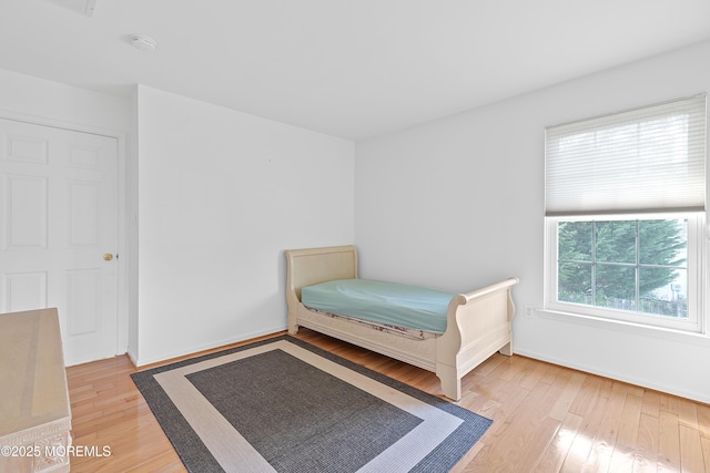 bedroom with baseboards and wood finished floors
