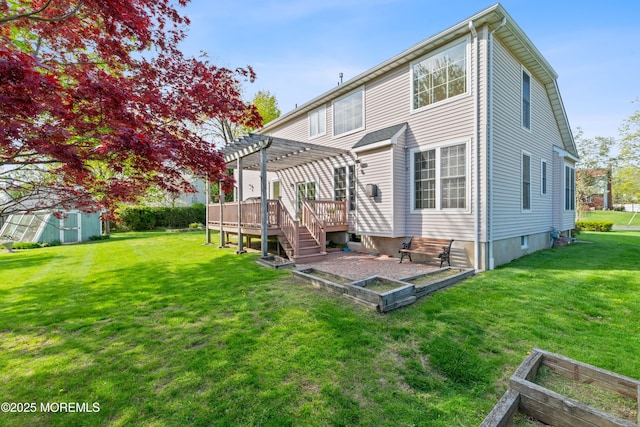 back of house featuring a yard, a pergola, and a wooden deck