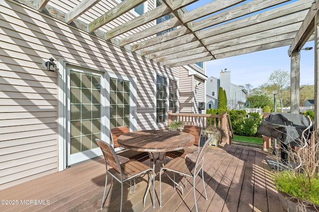 deck with grilling area, a pergola, and outdoor dining area