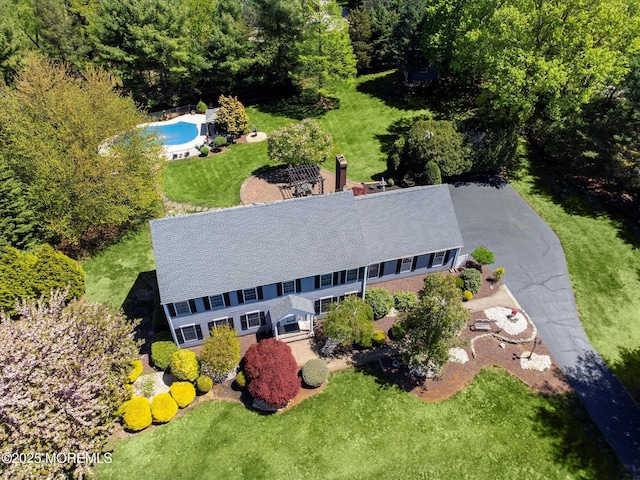 aerial view of property and surrounding area featuring a pool
