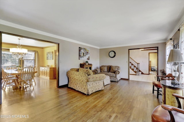 living area featuring light wood-style floors, a chandelier, stairs, ornamental molding, and baseboards