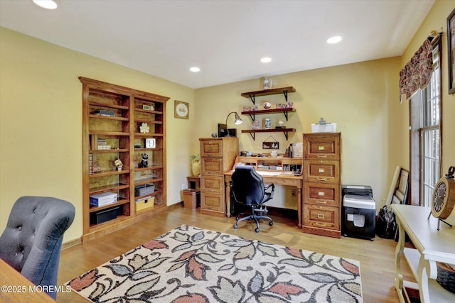 office area with light wood finished floors and recessed lighting