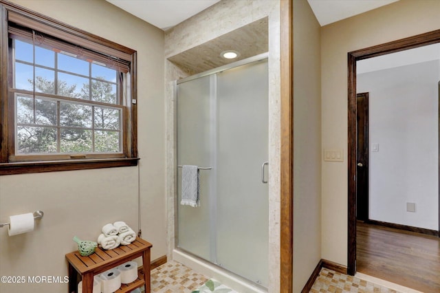 full bath featuring baseboards and a stall shower