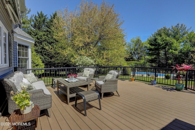 wooden deck with an outdoor hangout area and a swimming pool