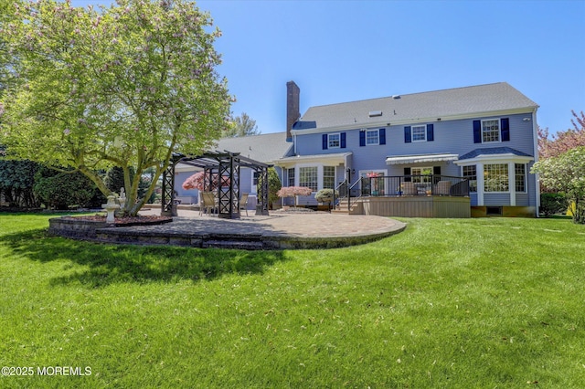 back of property featuring a pergola, a patio, a chimney, and a yard