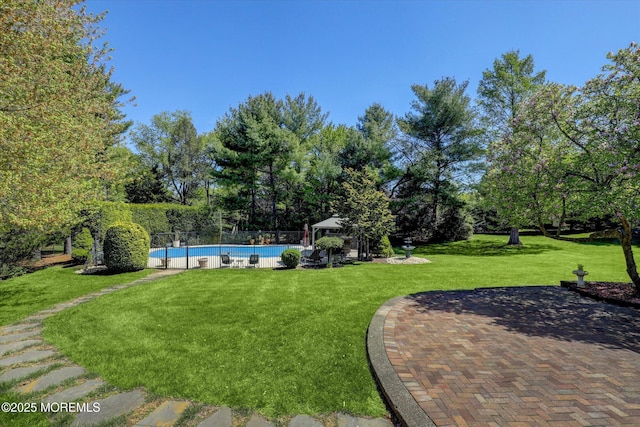 view of yard featuring a patio area, view of scattered trees, and a gazebo