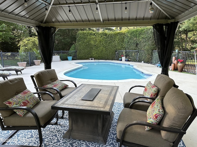 view of pool featuring a gazebo, fence, and a patio area