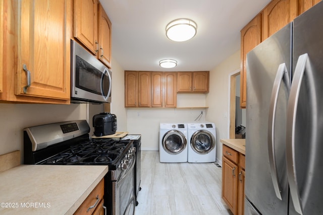 kitchen with light countertops, stainless steel appliances, brown cabinetry, and washing machine and dryer