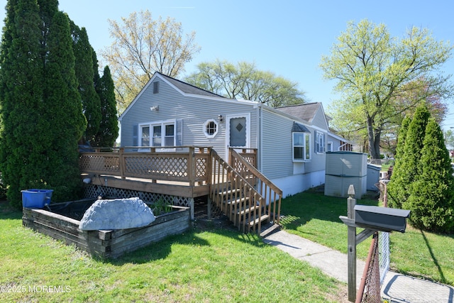 view of front of home featuring a front lawn and a deck