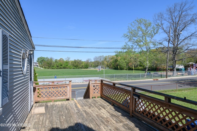 wooden terrace with a yard and fence
