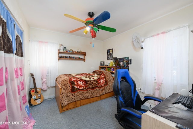 carpeted bedroom with crown molding and ceiling fan