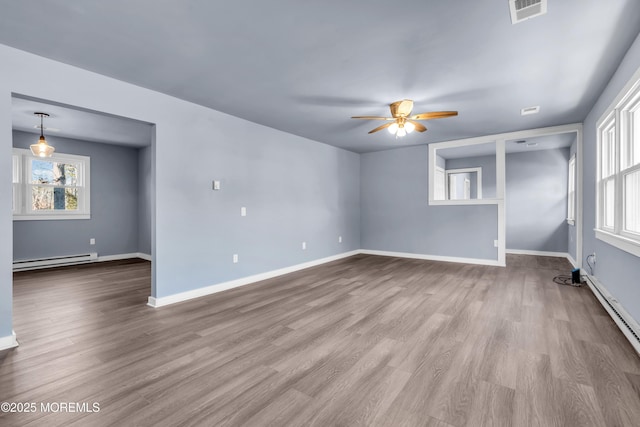 108 Manchester Ave, Forked River, NJ 08731 - unfurnished room with a baseboard heating unit, ceiling fan, visible vents, and wood finished floors